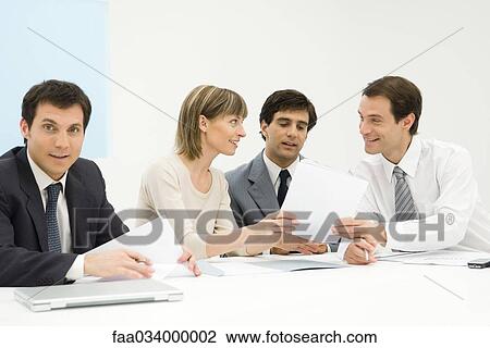 Business people in meeting, discussing document View Large Photo Image Stock Image - Business people in meeting, discussing document. Fotosearch