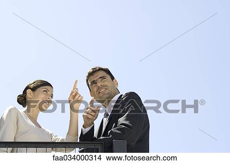 Businessman and businesswoman admiring view, pointing View Large Photo Image Picture - Businessman and businesswoman admiring view, pointing. Fotosearch