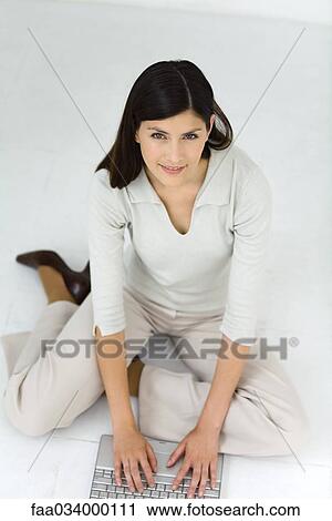 Businesswoman sitting on floor using laptop computer View Large Photo Image Stock Image - Businesswoman sitting on floor using laptop computer. Fotosearch