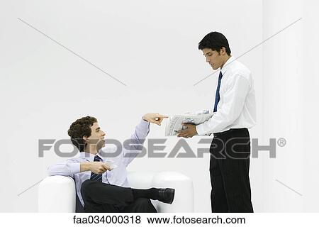 Coworkers on coffee break, discussing newspaper View Large Photo Image Stock Photo - Coworkers on coffee break, discussing newspaper. Fotosearch