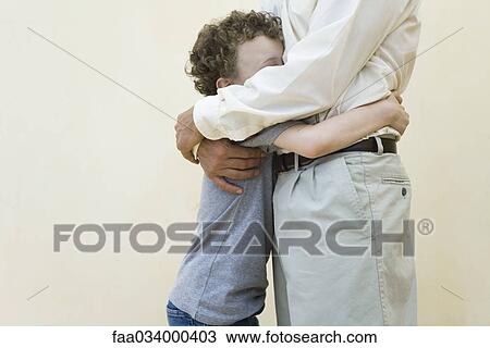 Father and son embracing, side view, cropped View Large Photo Image Stock Image - Father and son embracing, side view, cropped. Fotosearch