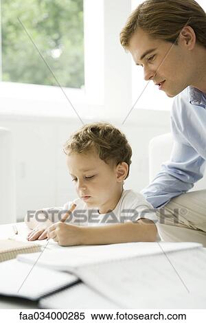 Stock Photography - Father helping young son with homework. Fotosearch