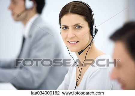 Female telemarketer smiling at camera, portrait View Large Photo Image Stock Image - Female telemarketer smiling at camera, portrait. Fotosearch