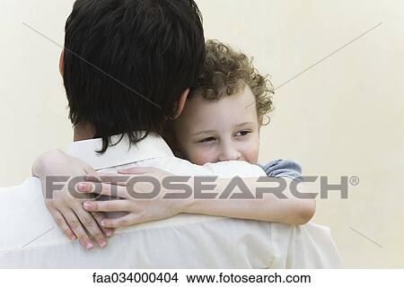 Little boy embracing father, looking away, close-up View Large Photo Image Picture - Little boy embracing father, looking away, close-up. Fotosearch