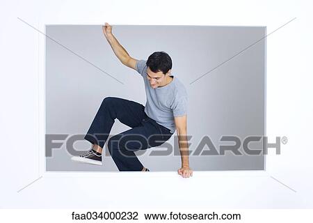 Man jumping over ledge, one arm raised View Large Photo Image Stock Image - Man jumping over ledge, one arm raised. Fotosearch