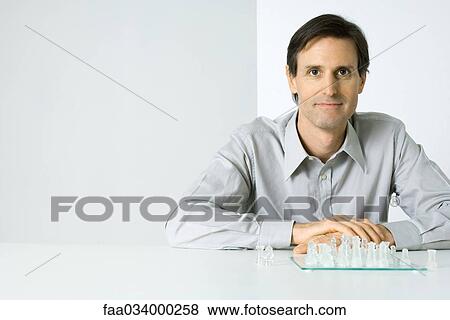 Man playing chess, smiling at camera View Large Photo Image Stock Photo - Man playing chess, smiling at camera. Fotosearch