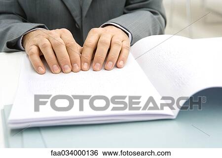 Man reading Braille document at desk, cropped view View Large Photo Image Stock Photograph - Man reading Braille document at desk, cropped view. Fotosearch