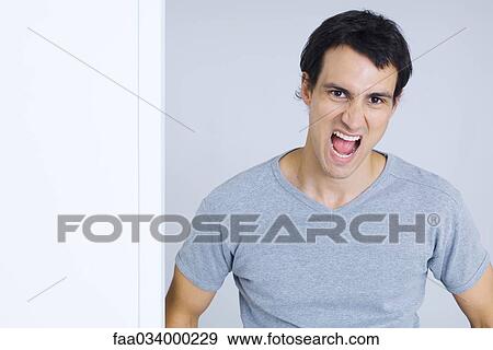 Stock Photo - Man shouting at camera, portrait. Fotosearch