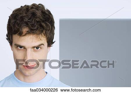 Man smirking at camera, one eyebrow raised View Large Photo Image Stock Photograph - Man smirking at camera, one eyebrow raised. Fotosearch
