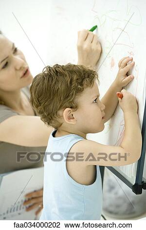 Mother and son drawing together, side view View Large Photo Image Stock Image - Mother and son drawing together, side view. Fotosearch