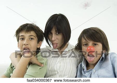 Mother and two sons sticking out tongues, one boy wearing clown's nose View Large Photo Image Stock Photo - Mother and two sons sticking out tongues, one boy wearing clown's nose. Fotosearch