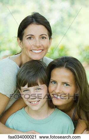Stock Image - Portrait of mother with teenage daughter and son. Fotosearch