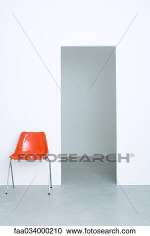 Red chair beside doorway View Large Photo Image Stock Image - Red chair beside doorway. Fotosearch
