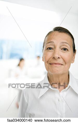 Senior woman smiling at camera, portrait View Large Photo Image Stock Image - Senior woman smiling at camera, portrait. Fotosearch