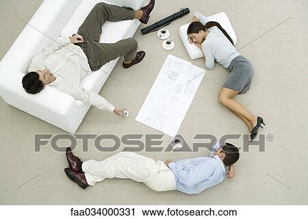 Team of professionals napping on floor and sofa, blueprint on the ground between them, overhead view View Large Photo Image Stock Image - Team of professionals napping on floor and sofa, blueprint on the ground between them, overhead view. Fotosearch