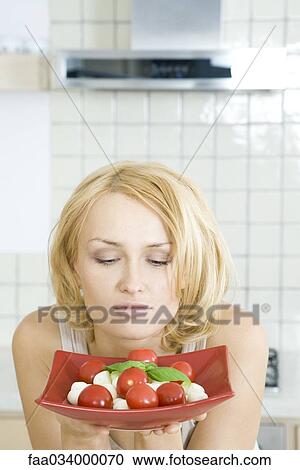 Woman contemplating plate of Caprese salad, looking down View Large Photo Image Stock Image - Woman contemplating plate of Caprese salad, looking down. Fotosearch