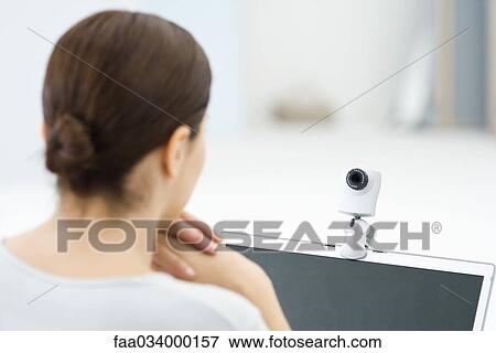 Woman looking at webcam, rear view View Large Photo Image Stock Photo - Woman looking at webcam, rear view. Fotosearch