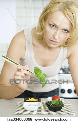 Woman preparing simple meal of vegetables View Large Photo Image Stock Photo - Woman preparing simple meal of vegetables. Fotosearch