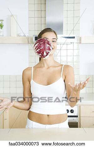 Woman with head of radicchio chicory falling in front of her face View Large Photo Image Stock Image - Woman with head of radicchio chicory falling in front of her face . Fotosearch