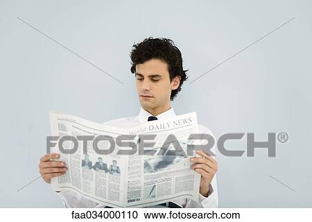 Young business man reading newspaper View Large Photo Image Stock Image - Young business man reading newspaper. Fotosearch
