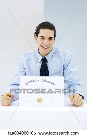 Young man receiving certificate of achievement View Large Photo Image Stock Photography - Young man receiving certificate of achievement . Fotosearch