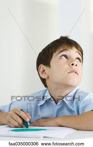 Boy coloring with crayon, looking up View Large Photo Image Stock Photograph - Boy coloring with crayon, looking up. Fotosearch