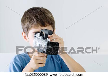 Boy using video camera View Large Photo Image Stock Photo - Boy using video camera. Fotosearch
