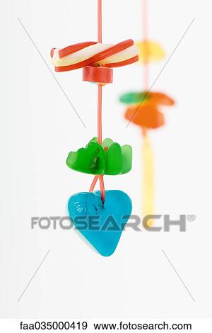 Colorful candy hanging on string View Large Photo Image Stock Photo - Colorful candy hanging on string. Fotosearch