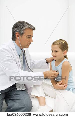 Doctor listening to girl's heart with stethoscope View Large Photo Image Stock Photograph - Doctor listening to girl's heart with stethoscope. Fotosearch