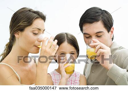 Family drinking orange juice together View Large Photo Image Stock Photo - Family drinking orange juice together. Fotosearch
