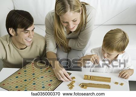 Family playing board game together, mother arranges game pieces View Large Photo Image Stock Image - Family playing board game together, mother arranges game pieces. Fotosearch
