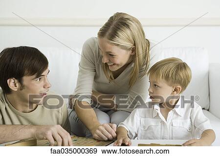 Family playing board game together View Large Photo Image Stock Photo - Family playing board game together. Fotosearch