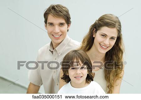 Stock Image - Family smiling at camera, portrait. Fotosearch