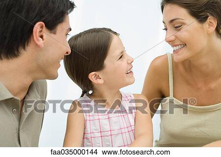 Family smiling at each other, cropped view View Large Photo Image Picture - Family smiling at each other, cropped view. Fotosearch