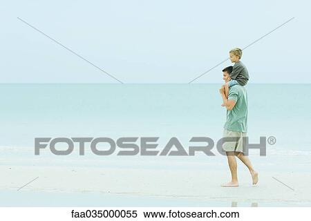 Father carrying son on shoulders, walking on deserted beach View Large Photo Image Stock Photography - Father carrying son on shoulders, walking on deserted beach. Fotosearch