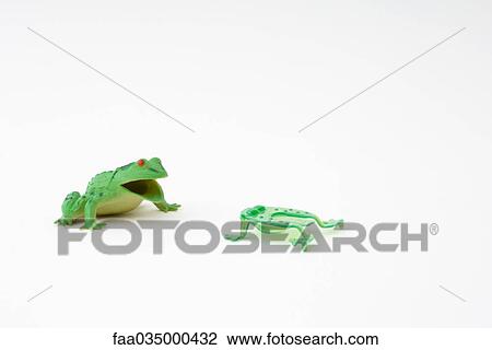 Frog toy facing smaller plastic frog View Large Photo Image Stock Image - Frog toy facing smaller plastic frog. Fotosearch