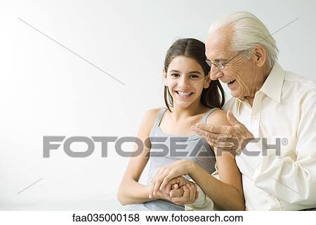 Grandfather and teen granddaughter holding hands, laughing View Large Photo Image Stock Photo - Grandfather and teen granddaughter holding hands, laughing. Fotosearch