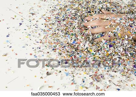 Stock Image - Hand covered in confetti. Fotosearch