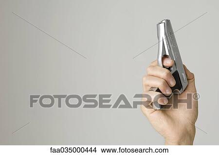 Hand holding pistol View Large Photo Image Picture - Hand holding pistol. Fotosearch