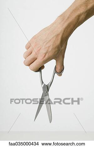 Hand holding scissors, close-up View Large Photo Image Picture - Hand holding scissors, close-up. Fotosearch