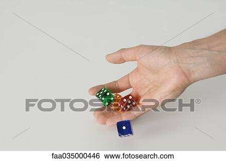 Stock Photograph - Hand rolling dice. Fotosearch
