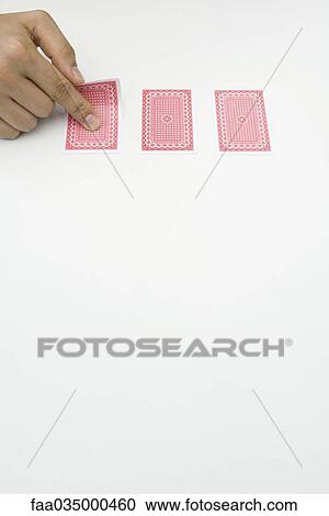 Hand turning over one of three cards View Large Photo Image Stock Image - Hand turning over one of three cards. Fotosearch