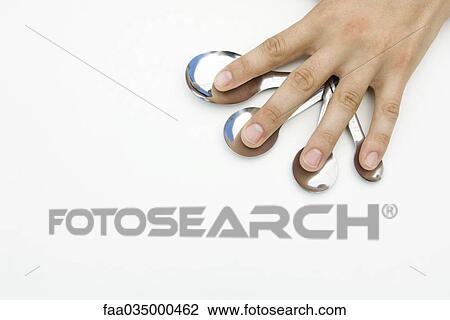 Hand with fingers spread over measuring spoons View Large Photo Image Stock Image - Hand with fingers spread over measuring spoons. Fotosearch