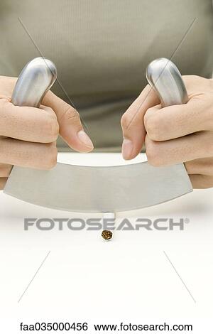 Hands cutting cigarette with mincing knife View Large Photo Image Stock Photograph - Hands cutting cigarette with mincing knife. Fotosearch