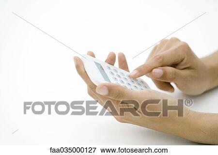 Hands holding calculator, pushing button, cropped view View Large Photo Image Stock Photo - Hands holding calculator, pushing button, cropped view. Fotosearch