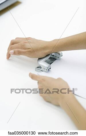 Hands using hole puncher View Large Photo Image Stock Image - Hands using hole puncher. Fotosearch