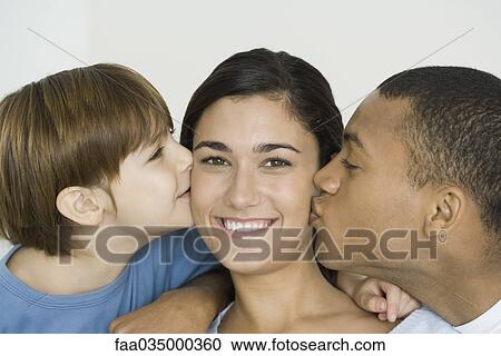 Husband and son kissing woman's cheeks, woman smiling at camera View Large Photo Image Stock Image - Husband and son kissing woman's cheeks, woman smiling at camera. Fotosearch