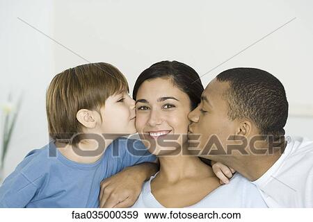 Husband and son kissing woman's cheeks, woman smiling at camera View Large Photo Image Stock Photo - Husband and son kissing woman's cheeks, woman smiling at camera. Fotosearch