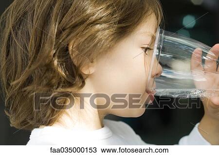 Little boy drinking water from glass, close-up View Large Photo Image Stock Image - Little boy drinking water from glass, close-up. Fotosearch