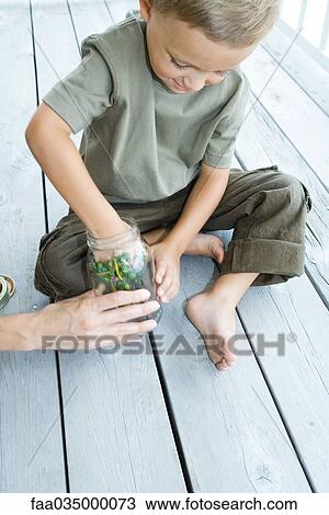 Little boy sitting on porch, placing berries into glass jar, high angle view View Large Photo Image Stock Image - Little boy sitting on porch, placing berries into glass jar, high angle view. Fotosearch